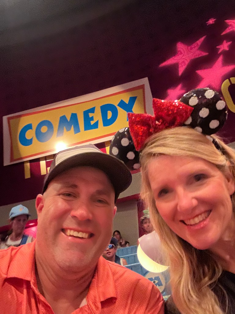 Ryan and Sarah inside Monsters, Inc. Laugh Floor under the Comedy sign