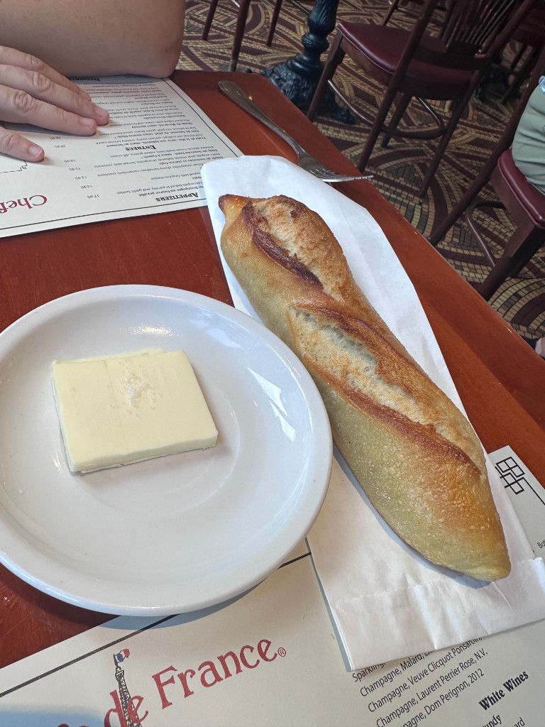 Crusty baguette and salted butter at Chefs de France