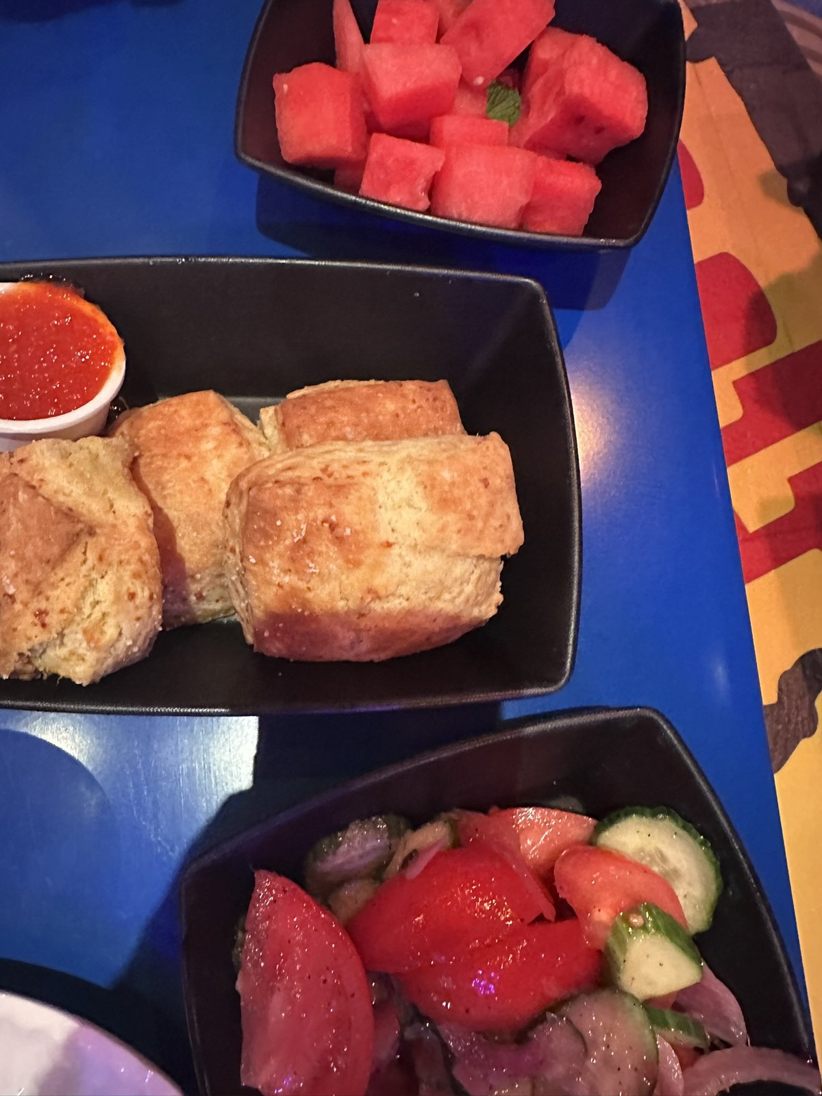 Cheddar biscuits with pepper jelly, tomato salad, and watermelon