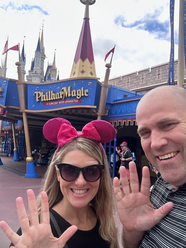 Ryan and Sarah ranking selfie in front of Mickey’s PhilharMagic