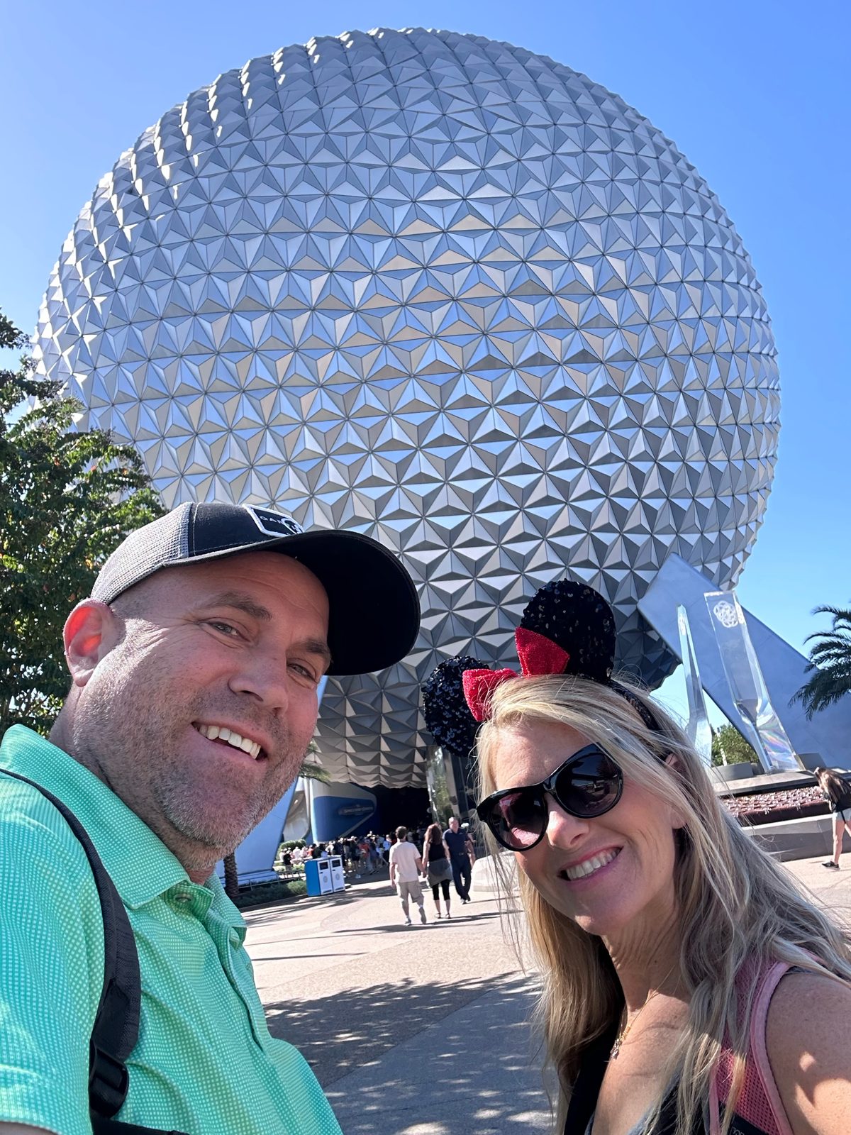 Ryan taking a selfie in front of Spaceship Earth at EPCOT