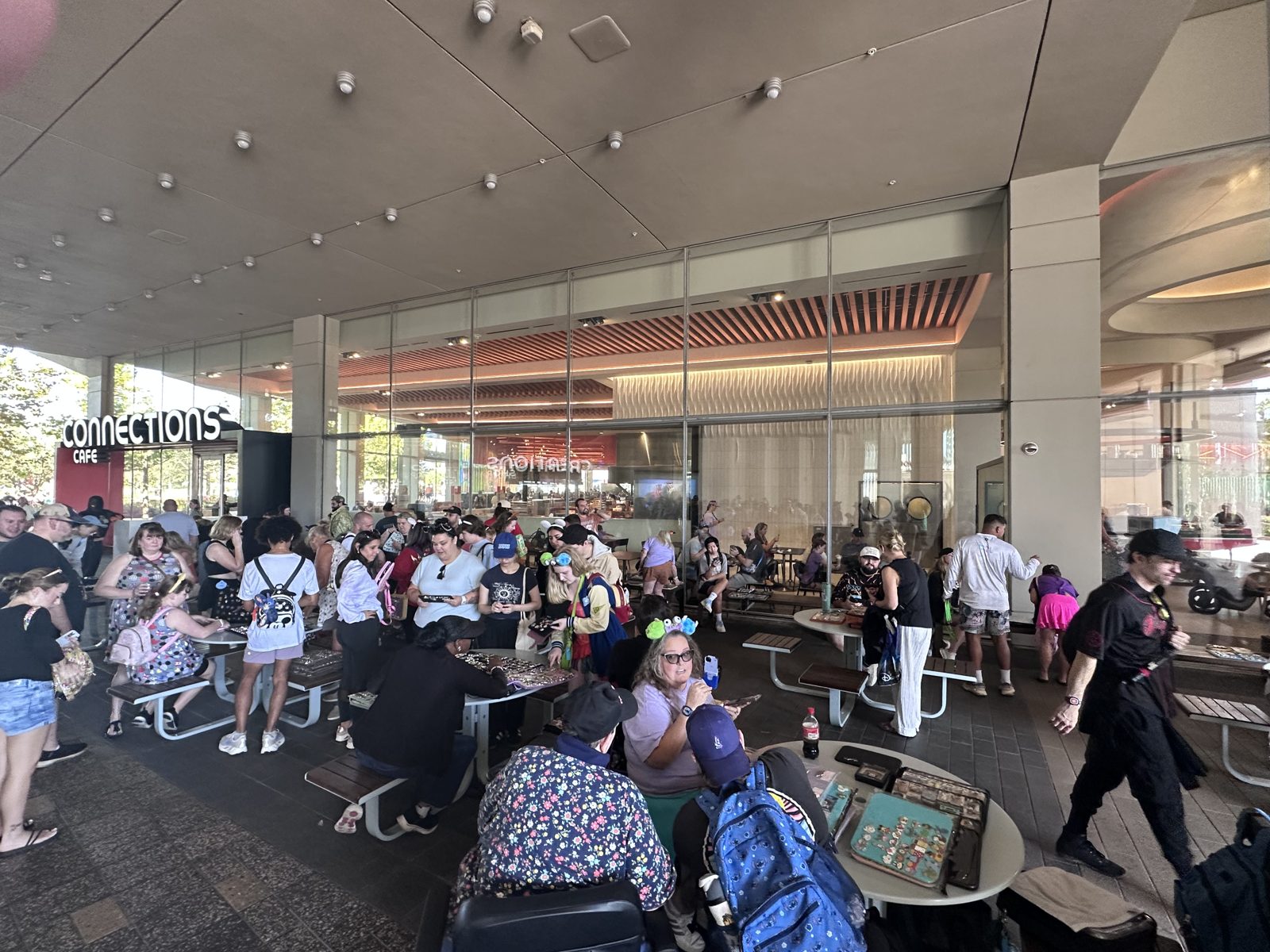 Crowd of pin traders with pin books outside Connections Cafe