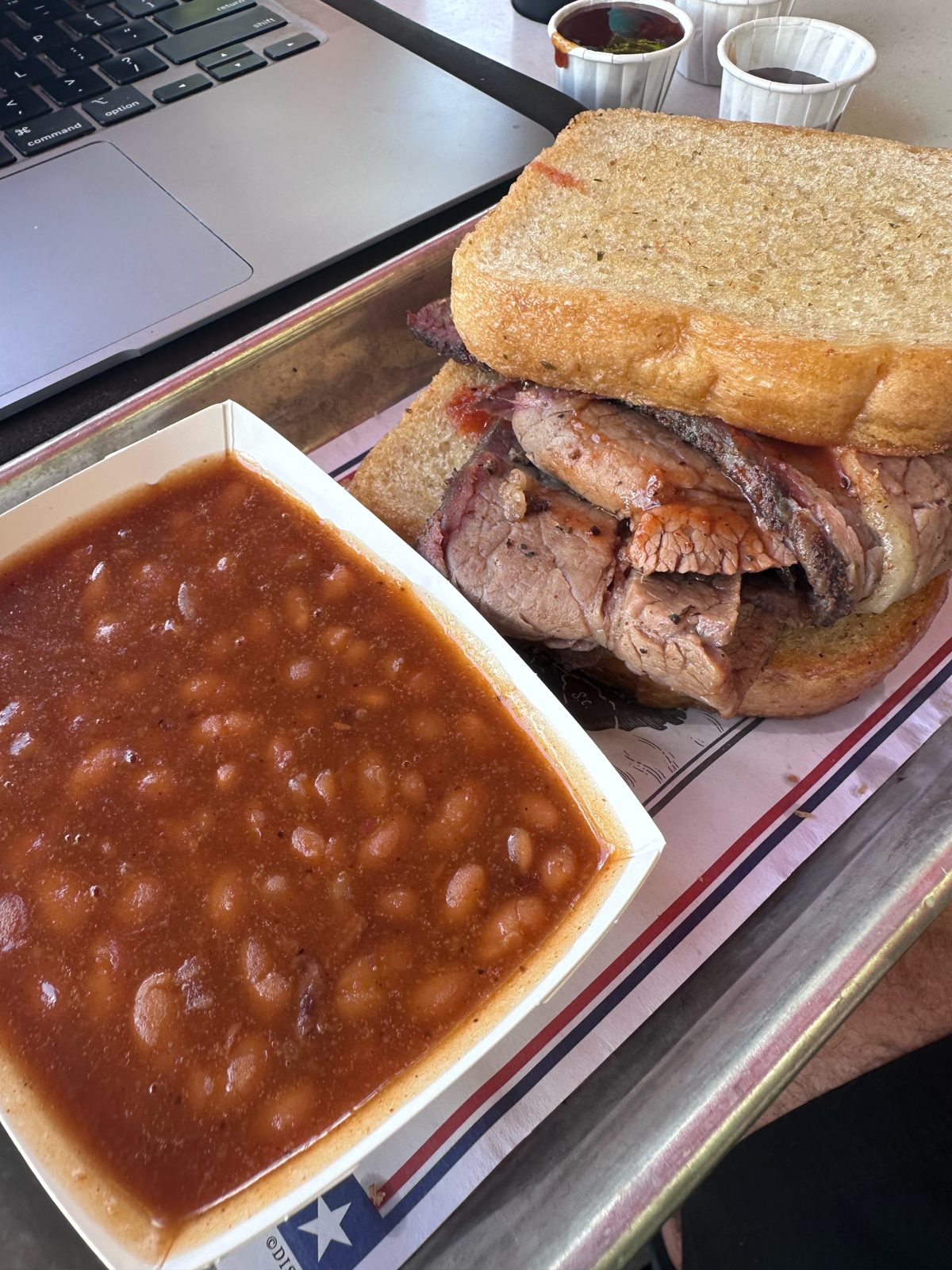 Texas brisket sandwich on Texas toast with baked beans from Regal Eagle Smokehouse
