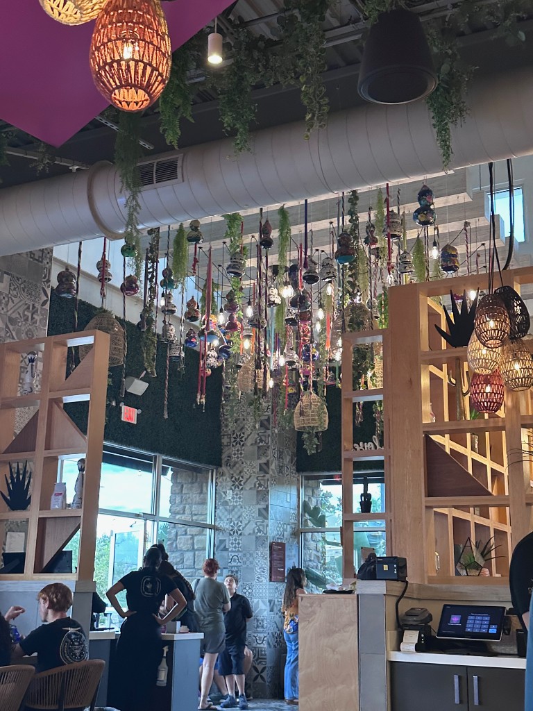 Hanging lanterns and host stand inside Don Julio Lake Nona