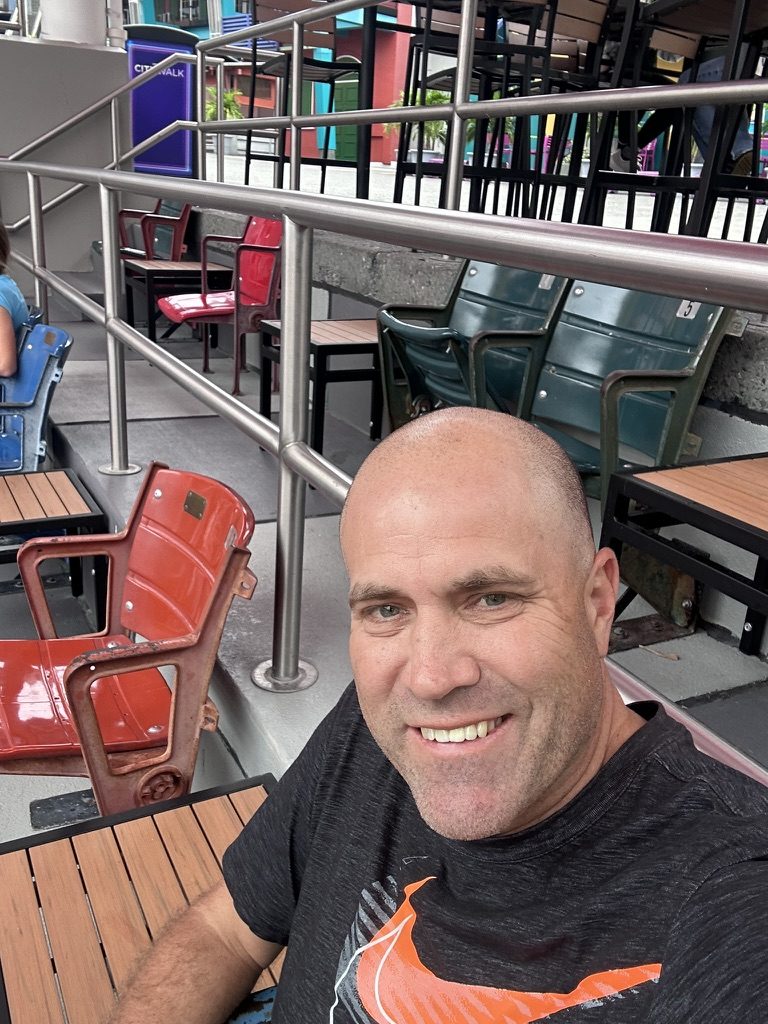 Ryan sitting among red and green stadium seats