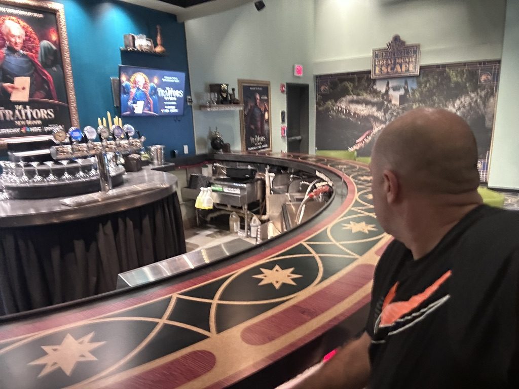 Ryan sitting at the star-patterned Roundtable bar, closed with no staff